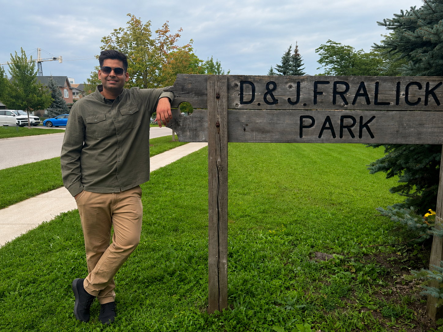 Asmar Naveed standing beside the D & J Fralick Park sign in Ward 9